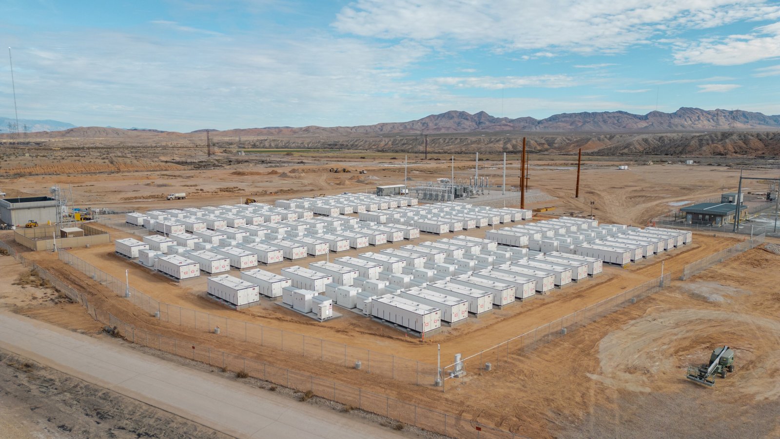 Rows of white battery storage containers at the Reid Gardner battery energy storage site in the Nevada desert